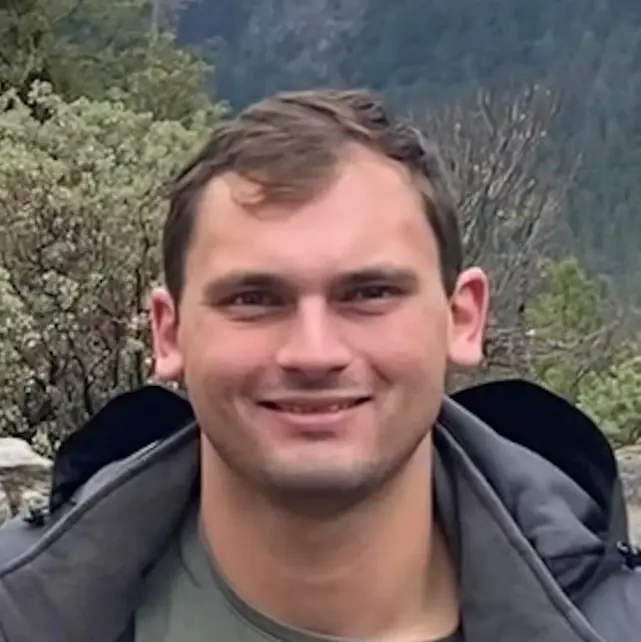 A headshot of Mitchell Hornsby with Yosemite valley in the background